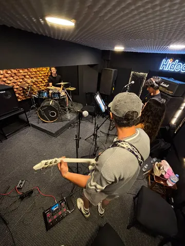Prova odasında grup provası — davul ve gitar bir arada